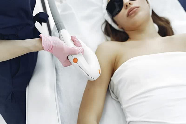 Woman doing laser hair removal on arms